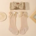 Close-up of baby girl bow headband and matching mesh knee-high socks set - Three-Piece Set / Khaki