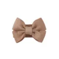 Detailed macro view of a brown grosgrain ribbon bow hair clip for toddlers and kids - Coffee