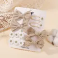 Set de pinzas para el pelo beige para niñas con lazos de tela y bordados de margaritas. - Caqui