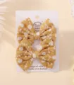 Pair of cute yellow fabric bow hair clips with white floral embroidery on display card - Floral Embroidered Bow (31)