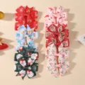 Eight-piece Christmas hair bow set for girls featuring festive Santa and holly designs - 12E (Christmas Tropical Combo)