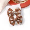 Pair of brown fabric bow hair clips with white floral embroidery on display card - Daisy Embroidered Bow (18)