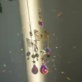 Detailed view of golden butterfly suncatcher hanging with rainbow crystal light effects - Butterfly Suncatcher Pendant / 1 Piece/Pack