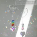 Detail of crystal suncatcher showing heart engraving and rainbow light reflections. - Sister Style