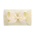 Soft and stretchy nylon baby headband featuring a large cream yellow grosgrain ribbon bow - Milk Yellow