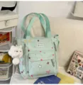 Mint green canvas tote bag with star prints, front pockets and cute plush cat pendant. - Tote Bag Green + Pendant