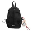 Macro view of a black canvas sling bag featuring a decorative bear plush charm detail - Black (With Bear Pendant) / One Size
