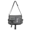 Close-up front view of a gray nylon utility messenger bag with THREE FEATHER label and straps - Messenger Bag (Includes Badges) / Gray