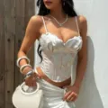 Detailed view of the white floral embroidered corset top with delicate lace trim and boning. - S / Pink