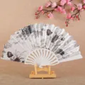 Elegant Chinese style folding hand fan with black white floral print and hollow plastic frame. - Off-White