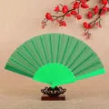Green folding hand fan for dancing and summer use, classic solid color plastic design sku. - Green