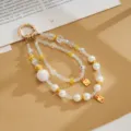 Exquisite detail of iridescent beaded phone strap featuring pearls and crown charm - Double Chain Crown Fortune Pendant / White