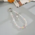 Detailed view of a pink and clear beaded phone charm with an elegant butterfly pendant. - Gemstone Butterfly Tassel Charm (K6585) / Pink