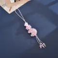 Macro view of pink relief moon charm with flower beads and delicate tassel cord - Embossed Moon Flower Accessory (K6557) / Pink