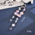 Close-up of a purple beaded keychain charm showing 17.7cm length and 23.9g weight. - Purple