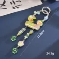 Detail view of candy-colored beaded charm showing length of 17.8cm and 24.1g weight - Green