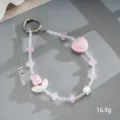 Detailopname van roze en witte kralen polsband met hart en bloem bedeltjes, 15,7 cm. - Telefoonaccessoire (K6423) / Wolk Strik Hart Hanger Roze