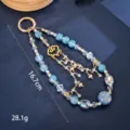 Detail of blue gold foil beaded phone charm with heart and butterfly pendants - Auspicious Cloud Heart Butterfly Style (K6331)