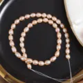 Detail view of natural freshwater pink rice pearls strand, perfect for DIY handmade jewelry. - One Strand Length 35cm Around 45 Pieces / Natural Pink Orange