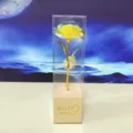Detailed view of a holographic gold foil rose in clear gift box with Best Wishes base. - Yellow