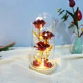 Detail view of the LED crystal rose glass dome night light, featuring warm glowing lights inside. - Gold Red