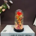 Gold foil rose glass dome gift with LED fairy lights and mother child figurine for home decor. - Iridescent