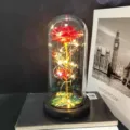 Detailed view of artificial gold foil rose glass dome light with warm LED fairy string. - Warm Light (Colored Gold, Red 3-Leaf)