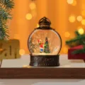 Close-up detail of Christmas snow globe lantern with glittering water and vintage bronze frame. - Kids