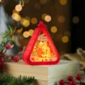 Detail of red triangle Christmas night light with glowing Santa Claus design for holiday decor. - Santa Claus / Red