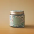 Detailed view of a scented candle in a glass jar with a mint and water lily label. - Water Lily & Mint