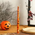 Halloween scented taper candle, orange wax with ghost and pumpkin print, 25cm party decor. - Orange
