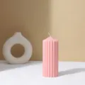 Detailed view of pink ribbed pillar candle minimalist home decor aesthetic ambiance prop. - Pink Spire Gear Cylinder Candles 7*17.5