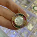Gold round religious pendant with mother-of-pearl carving and colorful baguette stones. - Colorful