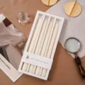 Detailaufnahme des Duftkerzen Sets in weißer Geschenkbox mit dekorativen Accessoires. - Milchweiß (Vanille-Creme)