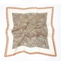 Close-up detail of vintage silk scarf featuring elegant leaf pattern and classic houndstooth border. - Coffee Houndstooth Patchwork