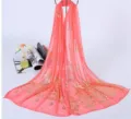 Detailed view of the coral pink chiffon scarf with elegant gold stamping designs. - Watermelon Red Satin Scarf