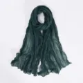 Detailed view of a dark green crinkled plain bali yarn scarf, soft lightweight shawl hijab. - Dark Green