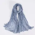 Close-up detail of the lightweight crinkled voile scarf texture in elegant blue shade. - Light Blue