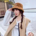Detailed view of the cozy brown shearling bucket hat worn by model, soft winter fleece warm hat. - M (56-58cm) / Caramel color