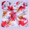 Detail view of a satin floral square scarf featuring vibrant red and grey flowers on white. - Red Large Floral Silk Scarf