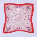 Detailed view of women printed silk square scarf with red border and floral design. - Small Floral Silk Scarf