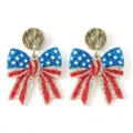Close-up detail of US Independence Day bow earrings with sparkling glitter stars and stripes. - Gold Stud Bow Knot Style (7)