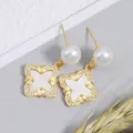 Elegant freshwater pearl clover earrings with white mother-of-pearl inlay and shiny rhinestones. - Clover Drop Earrings / White Mother of Pearl Gold