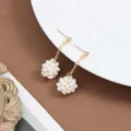 Close-up detail view of the handmade baroque freshwater pearl cluster flower earrings. - E2746 Earrings / Gold