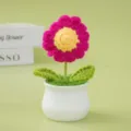 Handmade crochet daisy flower potted plant detail, featuring pink petals and green leaves. - Rose Red Daisy