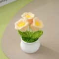 Handcrafted crochet yellow flower potted plant detail view, cute knitted desktop decor ornament. - Yellow