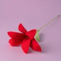 Handmade crochet red lily flower detail shot, realistic knitted floral decor accessory. - Red