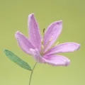 Handmade crochet pink lily flower detail view, beautiful knitted yarn floral decor piece. - Purple
