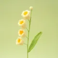 Handmade crochet yellow lily of the valley flower branch detail close up display. - Yellow