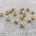 Close-up detail of 4mm twisted gold plated metal spacer beads for DIY handmade jewelry crafting. - 4mm / 100 Pieces/Pack / Gold